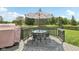 Inviting outdoor dining area with a Traeger grill and seating for six overlooking the serene backyard at 301 Cobblesprings Ct, Avon, IN 46123