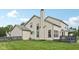 Side view of home showcasing spacious backyard, freshly cut lawn, and deck for entertaining at 301 Cobblesprings Ct, Avon, IN 46123