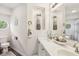 Bright bathroom featuring double sinks, decorative accents, and a large mirror at 301 Cobblesprings Ct, Avon, IN 46123