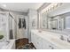 An elegant bathroom with double sinks, white cabinetry, and a tiled walk-in shower at 301 Cobblesprings Ct, Avon, IN 46123