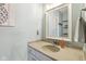 Elegant powder room features a framed mirror, stylish vanity, and soothing light-blue walls at 301 Cobblesprings Ct, Avon, IN 46123