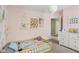 A charming bedroom featuring pink walls and a delightful display of floral decorations at 301 Cobblesprings Ct, Avon, IN 46123