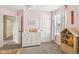 This bedroom showcases a neutral carpet, complementing the white dresser and a bright window at 301 Cobblesprings Ct, Avon, IN 46123