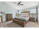A tranquil bedroom featuring a tufted headboard bed and natural light from two windows at 301 Cobblesprings Ct, Avon, IN 46123