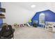 A spacious bonus room with a window, a play kitchen and ample space for games at 301 Cobblesprings Ct, Avon, IN 46123