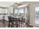 Charming breakfast nook featuring a table with seating for four, a water view, and modern lighting at 301 Cobblesprings Ct, Avon, IN 46123