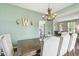 Cozy dining room with view to the kitchen, featuring seating for six and decorative chandelier at 301 Cobblesprings Ct, Avon, IN 46123