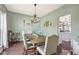 Charming dining room with a wooden table, decorative chandelier, and stylish upholstered chairs at 301 Cobblesprings Ct, Avon, IN 46123