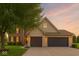 Charming home featuring a brick and vinyl exterior with a spacious three-car garage and well-maintained lawn at 301 Cobblesprings Ct, Avon, IN 46123