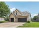 Spacious three-car garage with ample parking space and a well-manicured lawn surrounding the property at 301 Cobblesprings Ct, Avon, IN 46123