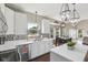 Bright kitchen features white cabinetry, modern backsplash, stainless steel appliances, and an adjacent dining area at 301 Cobblesprings Ct, Avon, IN 46123