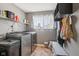 Functional laundry room features modern washer and dryer, shelving, and ample storage space at 301 Cobblesprings Ct, Avon, IN 46123