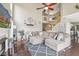 Spacious living room with a vaulted ceiling, fireplace, hardwood floors, and staircase in the background at 301 Cobblesprings Ct, Avon, IN 46123