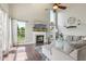 Bright living room with a vaulted ceiling, fireplace, large windows, and hardwood floors at 301 Cobblesprings Ct, Avon, IN 46123