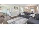 Inviting living room with hardwood floors, comfortable seating, and a view into the dining area at 301 Cobblesprings Ct, Avon, IN 46123