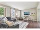 Bright living room with hardwood floors, large windows, and comfortable seating at 301 Cobblesprings Ct, Avon, IN 46123