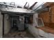 An unfinished basement with exposed pipes and a water heater at 320 N Colorado Ave, Indianapolis, IN 46201
