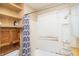 Bathroom with open shelves, shower curtain, and tub with surround at 320 N Colorado Ave, Indianapolis, IN 46201
