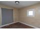 Bedroom with neutral walls, window and outdated carpeting at 320 N Colorado Ave, Indianapolis, IN 46201
