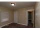 Bedroom with drab walls, blinds and neutral carpeting at 320 N Colorado Ave, Indianapolis, IN 46201