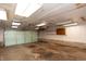 A spacious garage with an overhead door and fluorescent lighting at 320 N Colorado Ave, Indianapolis, IN 46201