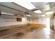 A spacious garage with fluorescent lights and shelving at 320 N Colorado Ave, Indianapolis, IN 46201