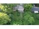 An aerial view of a home with a lush green backyard surrounded by mature trees offering privacy and seclusion at 3253 W 34Th St, Indianapolis, IN 46222
