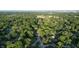 An aerial view of a home surrounded by lush greenery in a vibrant neighborhood on a sunny day at 3253 W 34Th St, Indianapolis, IN 46222