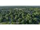 An aerial view of a home surrounded by lush greenery in a vibrant neighborhood with easy access to amenities at 3253 W 34Th St, Indianapolis, IN 46222