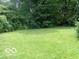 Spacious backyard featuring mature trees and lush lawn at 3253 W 34Th St, Indianapolis, IN 46222