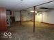 Unfinished basement featuring concrete floors and support beams at 3253 W 34Th St, Indianapolis, IN 46222