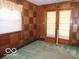 Bedroom with unique wooden paneling on the walls, providing a warm and vintage aesthetic at 3253 W 34Th St, Indianapolis, IN 46222