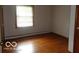 Bedroom featuring hardwood floors and a window for natural light, ready to be personalized at 3253 W 34Th St, Indianapolis, IN 46222