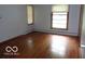 Spacious bedroom with hardwood floors and ample natural light from two windows at 3253 W 34Th St, Indianapolis, IN 46222