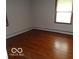Cozy bedroom featuring hardwood floors and a bright window for plenty of natural light at 3253 W 34Th St, Indianapolis, IN 46222