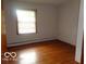 Bedroom featuring hardwood floors, complete with a window for natural light and fresh air at 3253 W 34Th St, Indianapolis, IN 46222