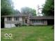 Charming single-story home with stone accents, lush lawn, and attached two-car garage at 3253 W 34Th St, Indianapolis, IN 46222
