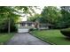 Charming two-story home with stone accents, green shutters, and an attached garage situated on a lush green lawn at 3253 W 34Th St, Indianapolis, IN 46222