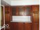 Detailed view of wooden kitchen cabinets with glass inserts and marble countertops at 3253 W 34Th St, Indianapolis, IN 46222