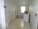 This is the laundry room featuring a window and a washing machine at 3253 W 34Th St, Indianapolis, IN 46222