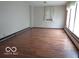 Spacious living room featuring hardwood floors and a large window at 3253 W 34Th St, Indianapolis, IN 46222
