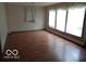Bright living room featuring hardwood floors and multiple windows at 3253 W 34Th St, Indianapolis, IN 46222