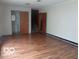 Living room showing hardwood floors and entryway to the bathroom at 3253 W 34Th St, Indianapolis, IN 46222