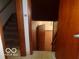 Stairway with wooden trim, leading to hardwood floor and additional room at 3253 W 34Th St, Indianapolis, IN 46222