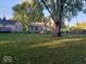 Spacious backyard with mature trees and a house at 335 Park St, Noblesville, IN 46060
