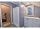 Bathroom with a white curtain and cabinets, with access to another room at 335 Park St, Noblesville, IN 46060