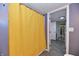 Bathroom features a yellow curtain, tile floor and an entrance to another room at 335 Park St, Noblesville, IN 46060