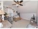 Bright bedroom boasts a ceiling fan, pitched ceilings, carpet, and comfortable seating at 335 Park St, Noblesville, IN 46060