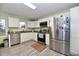 Modern kitchen with stainless steel appliances, white cabinets, and granite countertops at 335 Park St, Noblesville, IN 46060
