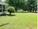 Well-maintained backyard with lush greenery, mature trees, and ample space for outdoor activities and relaxation at 336 N Windsong Ln, Greenwood, IN 46142